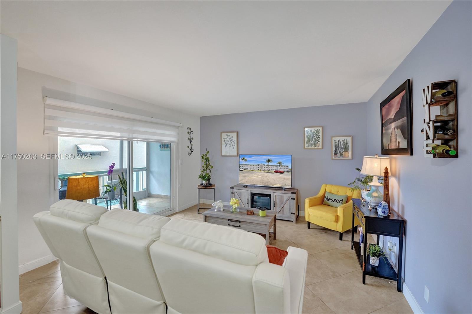 5300 Washington Street, Unit I203 Hollywood, FL 33021 - Photo 3 of 75 a living room with furniture and a fireplace