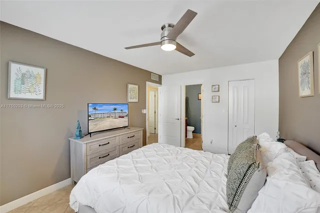 a bathroom with a granite countertop sink a toilet a mirror and vanity