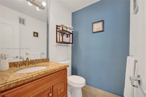 a bathroom with a granite countertop sink a mirror and shower