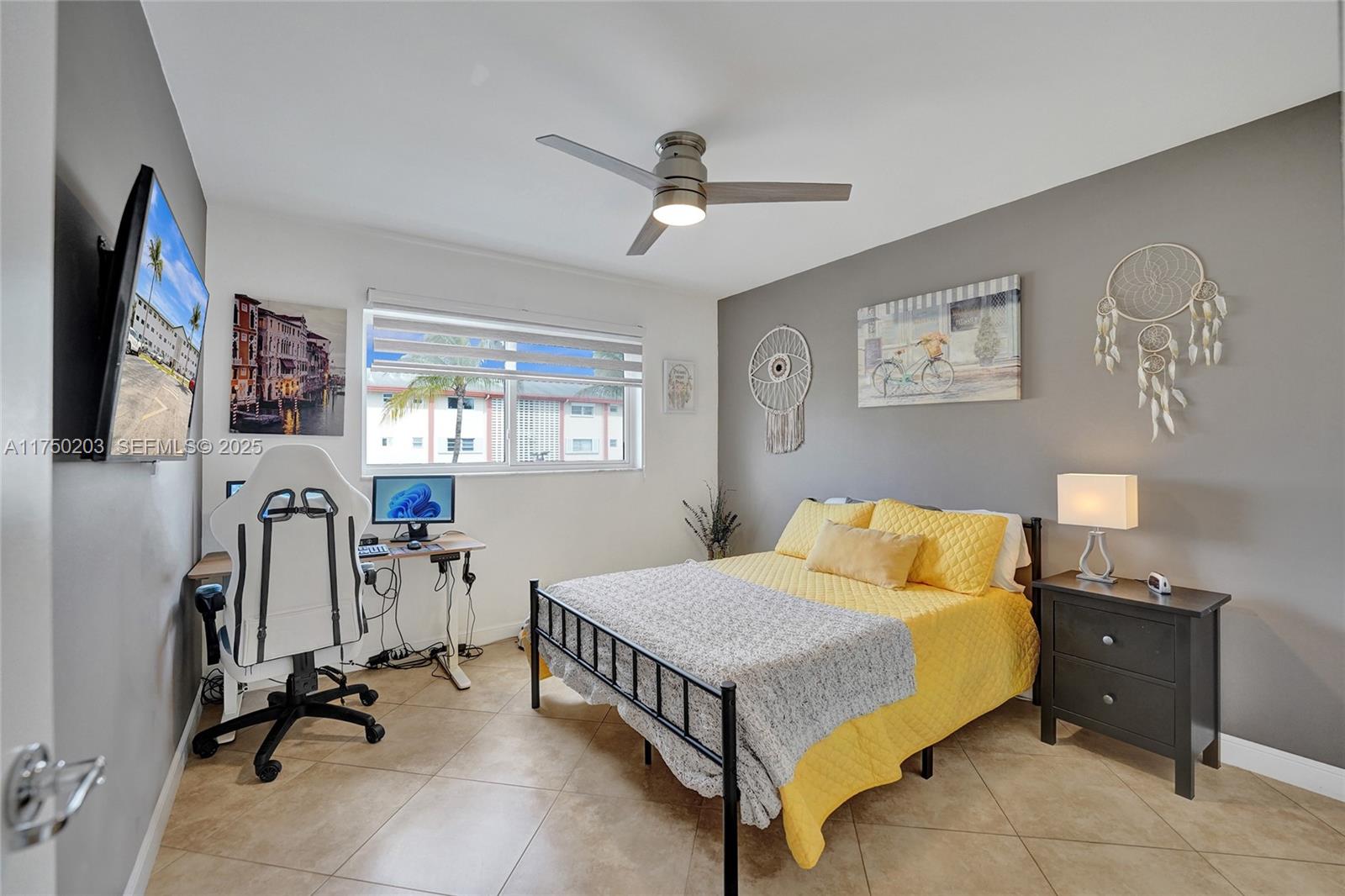 5300 Washington Street, Unit I203 Hollywood, FL 33021 - Photo 40 of 75 a bedroom that has a bed and a flat tv screen on the wall