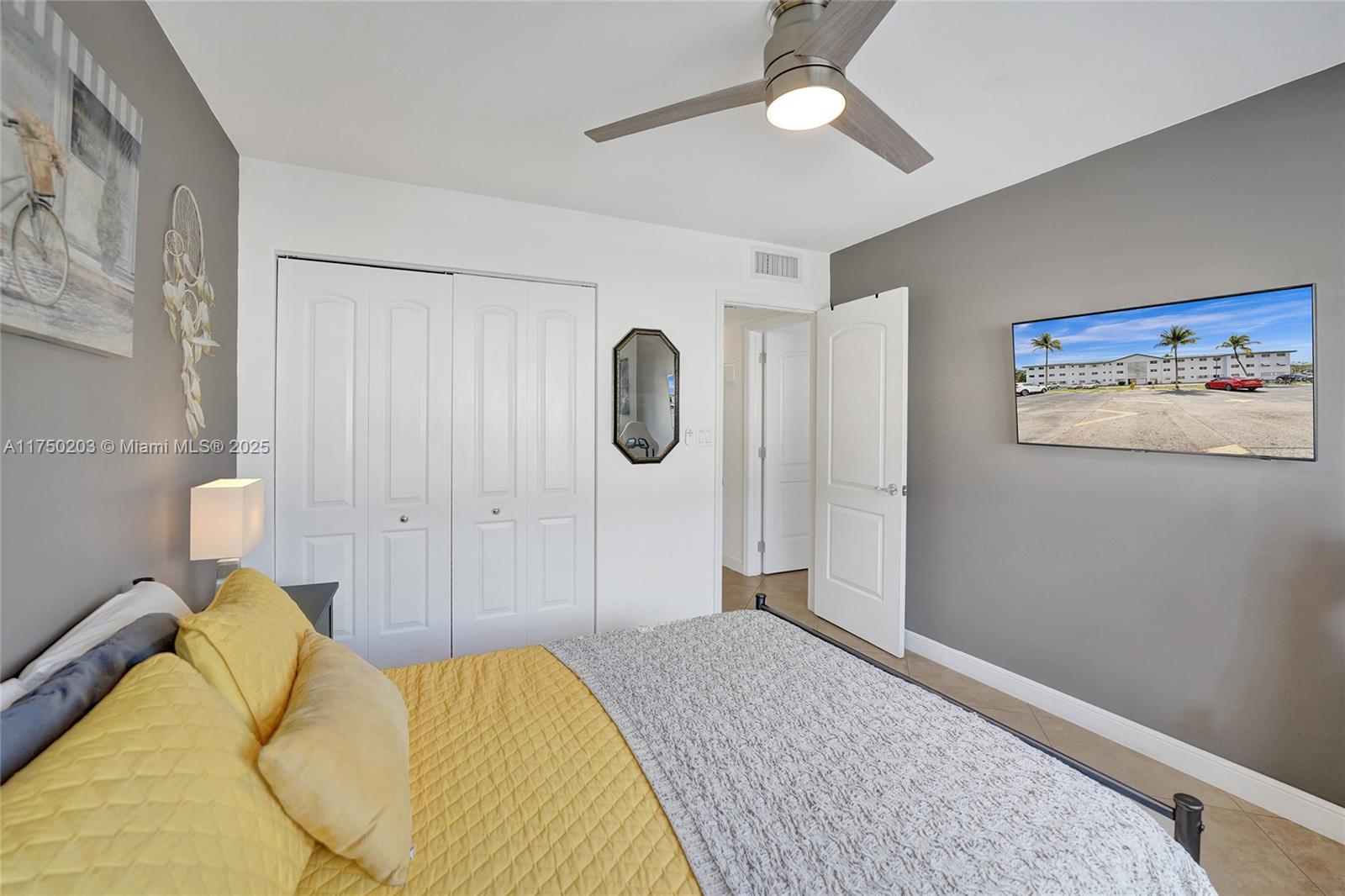 5300 Washington Street, Unit I203 Hollywood, FL 33021 - Photo 44 of 75 a spacious bedroom with a bed and a chandelier