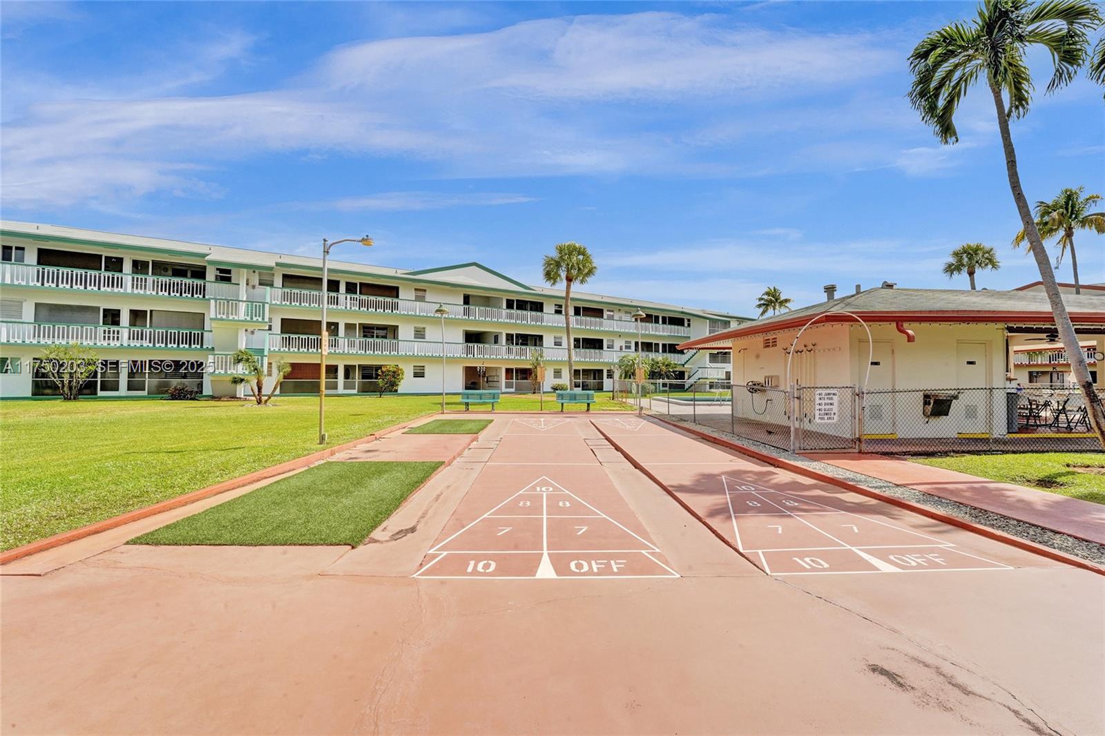 5300 Washington Street, Unit I203 Hollywood, FL 33021 - Photo 51 of 75 a view of a big building with a big yard and palm trees