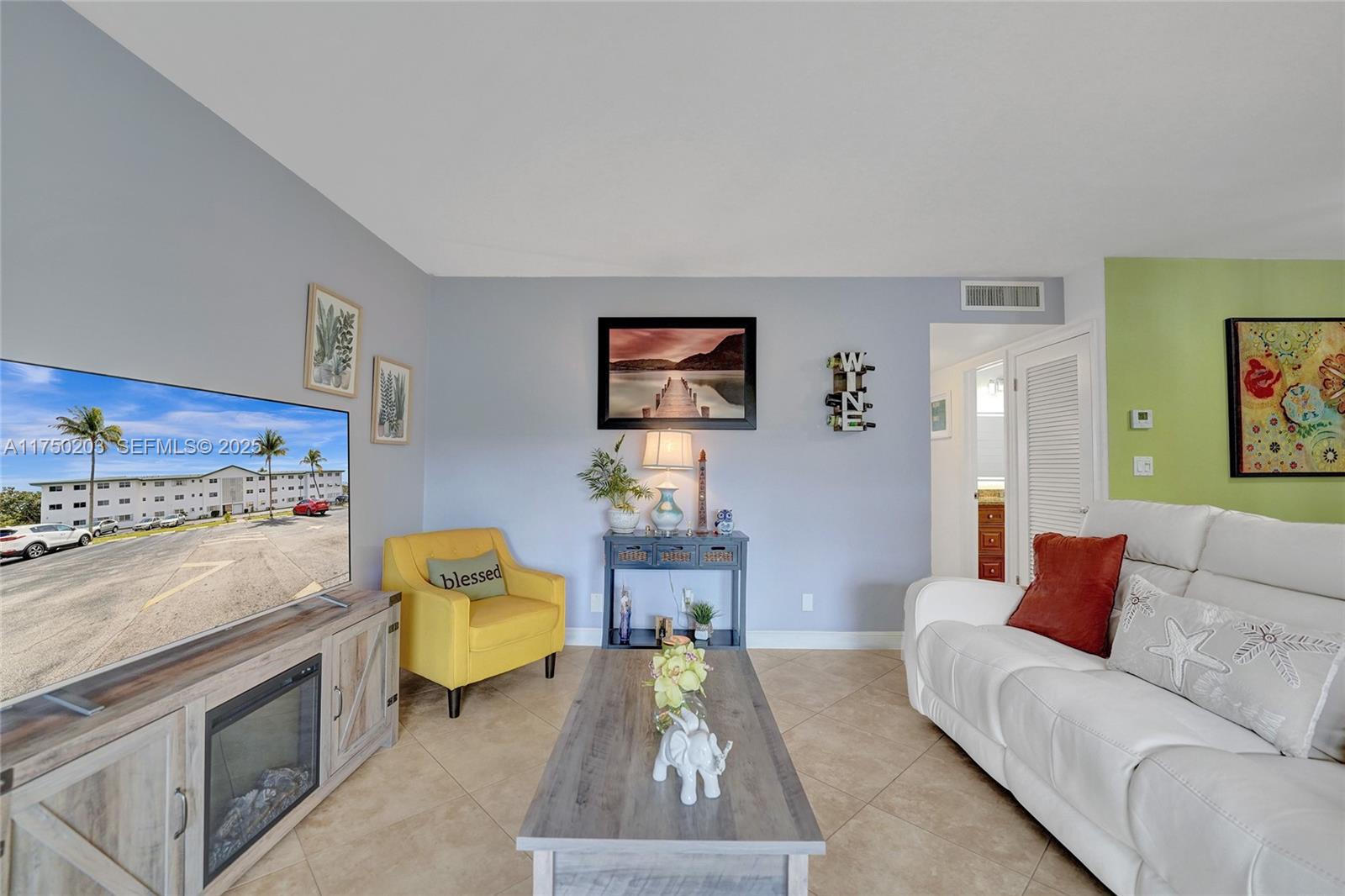 5300 Washington Street, Unit I203 Hollywood, FL 33021 - Photo 7 of 75 a living room with furniture and painting on the wall