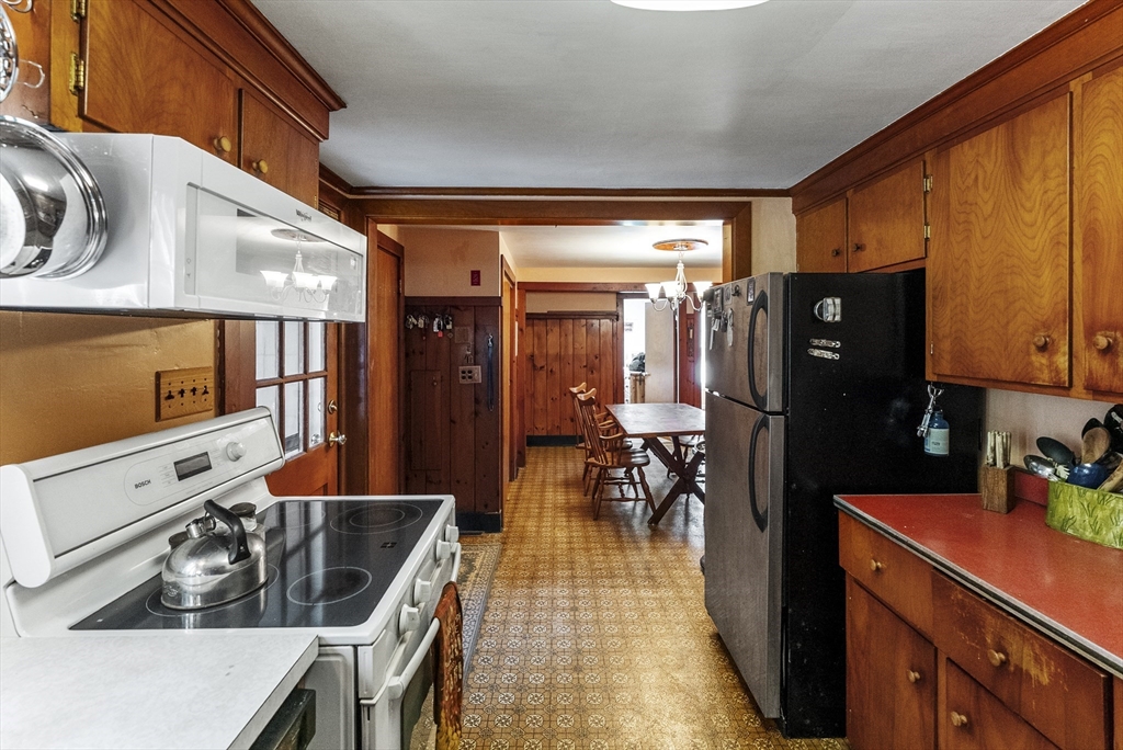 115 Kennedy Road Stoughton, MA 02072 - Photo 12 of 42 a kitchen with stainless steel appliances granite countertop a sink and a refrigerator