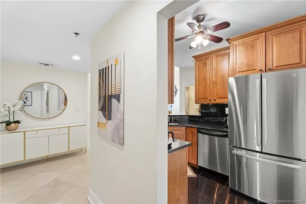 a kitchen with stainless steel appliances a refrigerator sink and cabinets