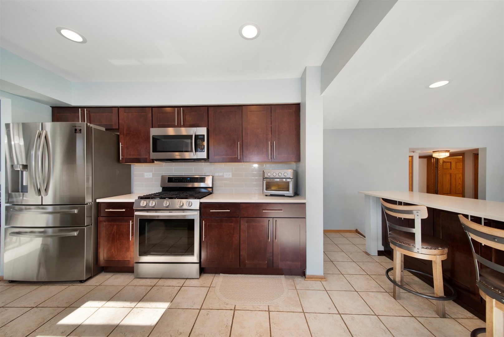 146 Sumac Lane Schaumburg, IL 60193 - Photo 5 of 24 a kitchen with granite countertop a refrigerator and a stove top oven