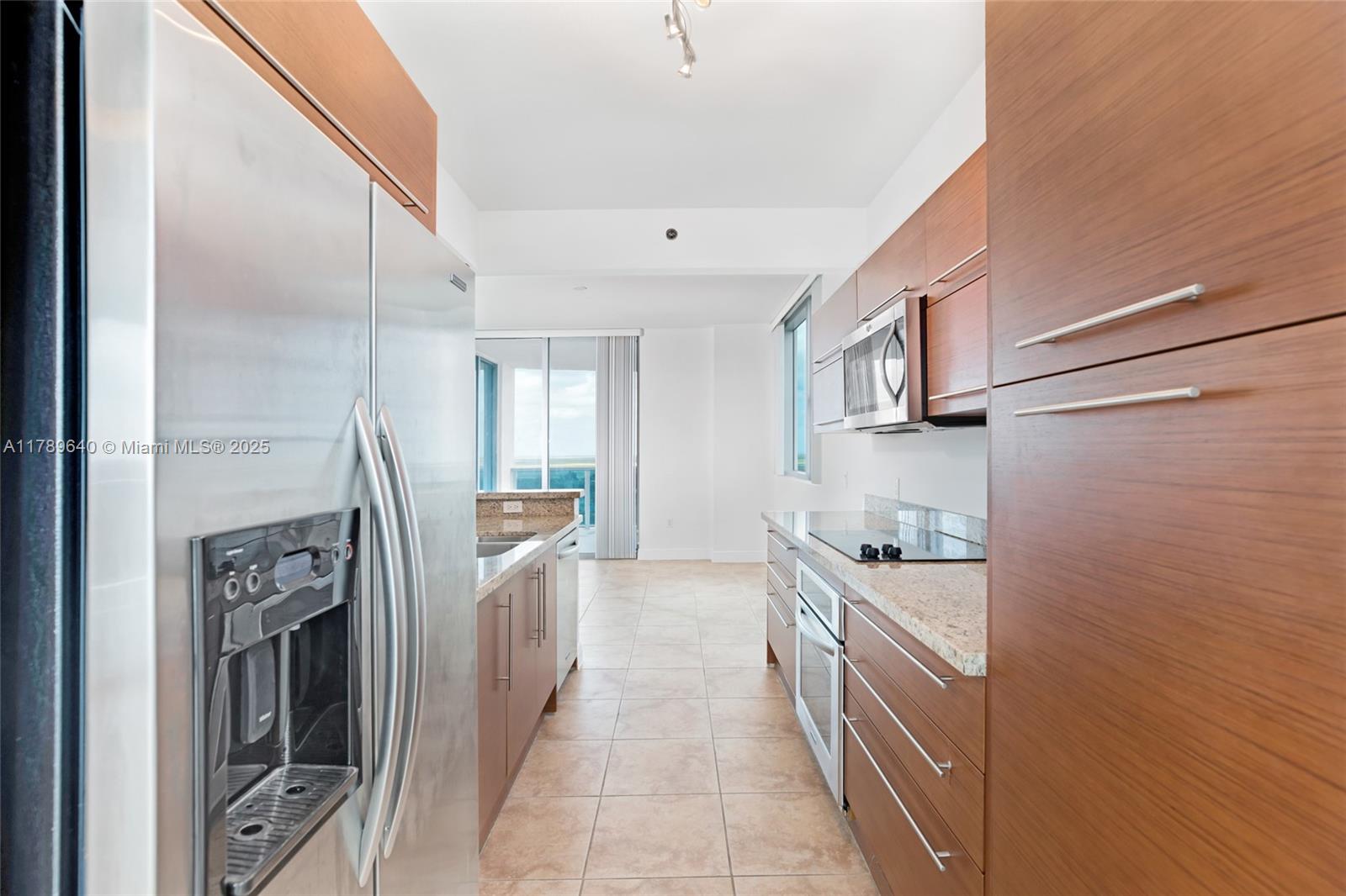 2641 North Flamingo Road, Unit 2608N Sunrise, FL 33323 - Photo 3 of 15 a kitchen with stainless steel appliances granite countertop a refrigerator and a stove