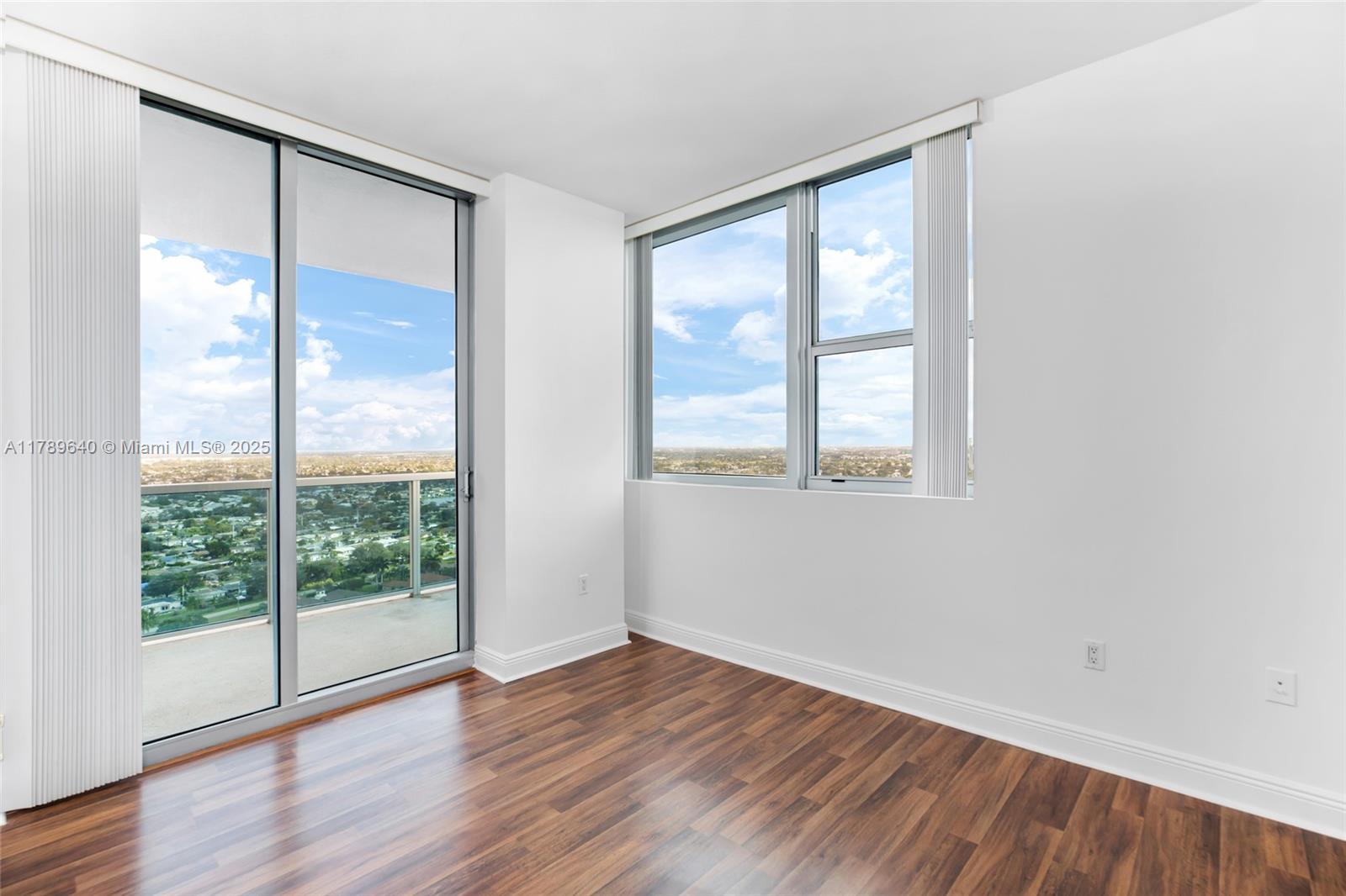 2641 North Flamingo Road, Unit 2608N Sunrise, FL 33323 - Photo 7 of 15 a view of an empty room with wooden floor and a window
