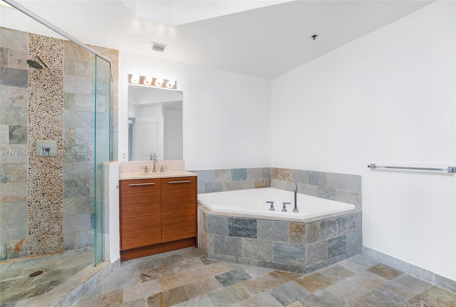 2641 North Flamingo Road, Unit 2608N Sunrise, FL 33323 - Photo 8 of 15 a bathroom with a bathtub a sink and a mirror