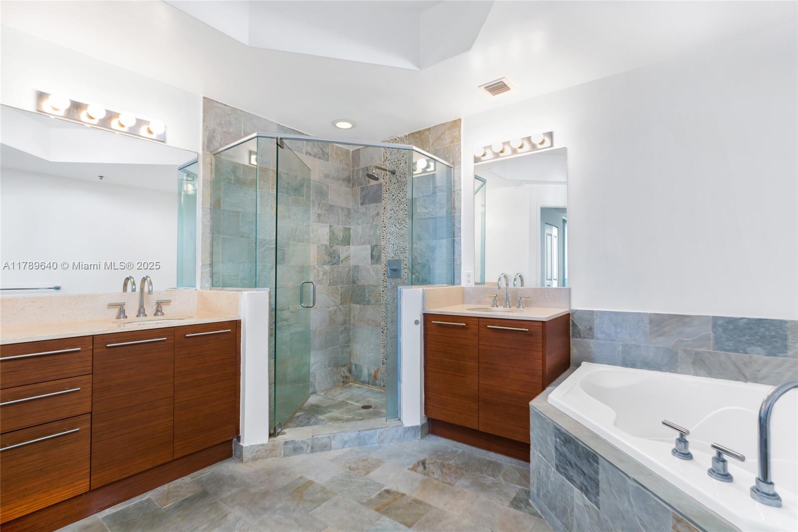 2641 North Flamingo Road, Unit 2608N Sunrise, FL 33323 - Photo 9 of 15 a bathroom with a tub sink shower and mirror