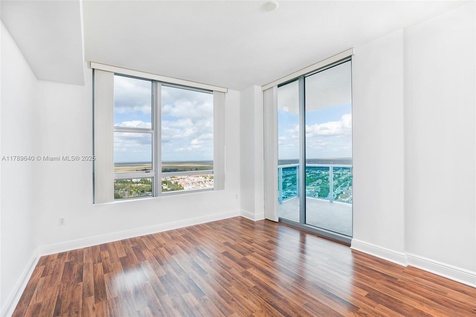2641 North Flamingo Road, Unit 2608N Sunrise, FL 33323 - Photo 10 of 15 a view of an empty room with wooden floor and a window