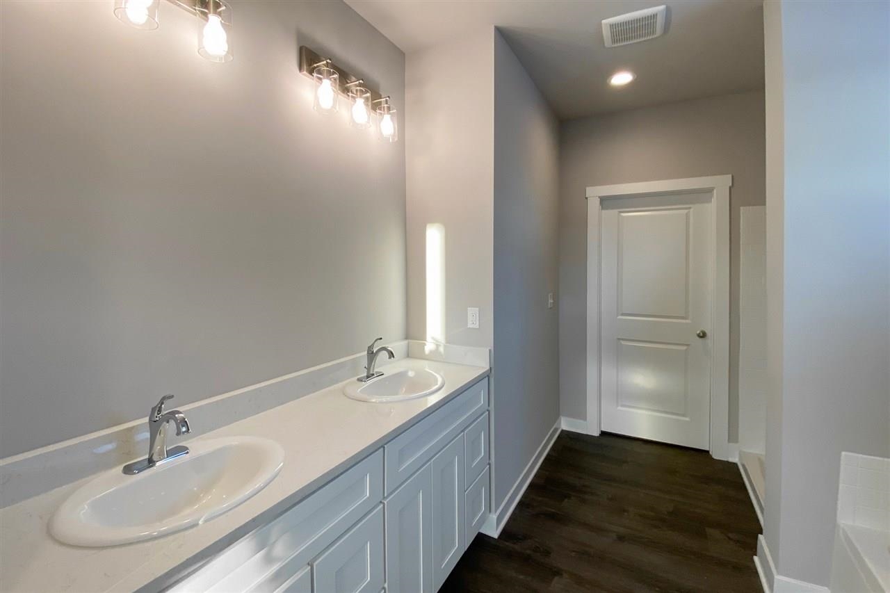2510 Court Ridge Road Belvidere, IL 61008 - Photo 15 of 22 a en suite bathroom with a double vanity sink and a mirror