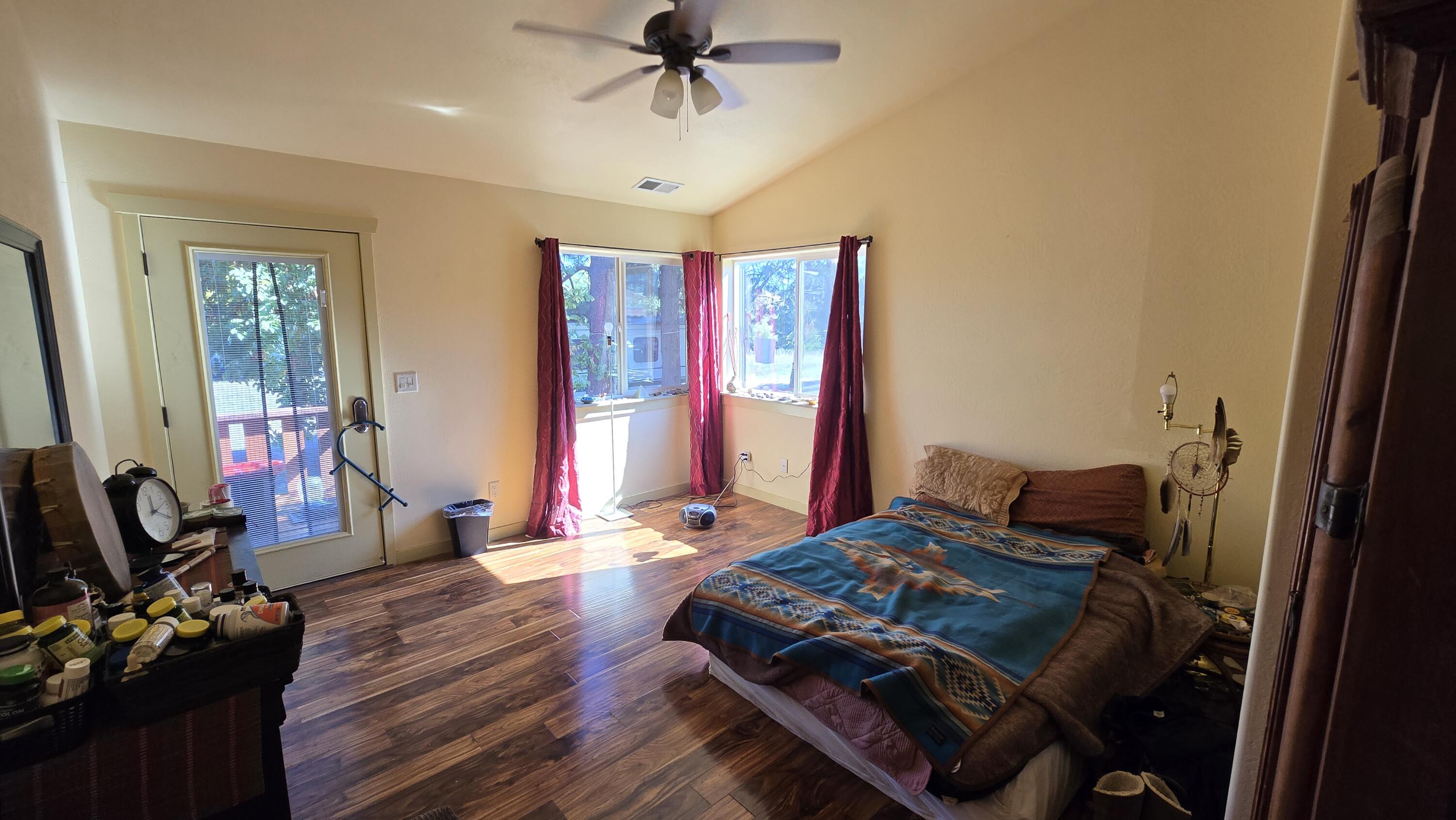 488 Crowson Road Ashland, OR 97520 - Photo 18 of 30 a bedroom with bed and wooden floor