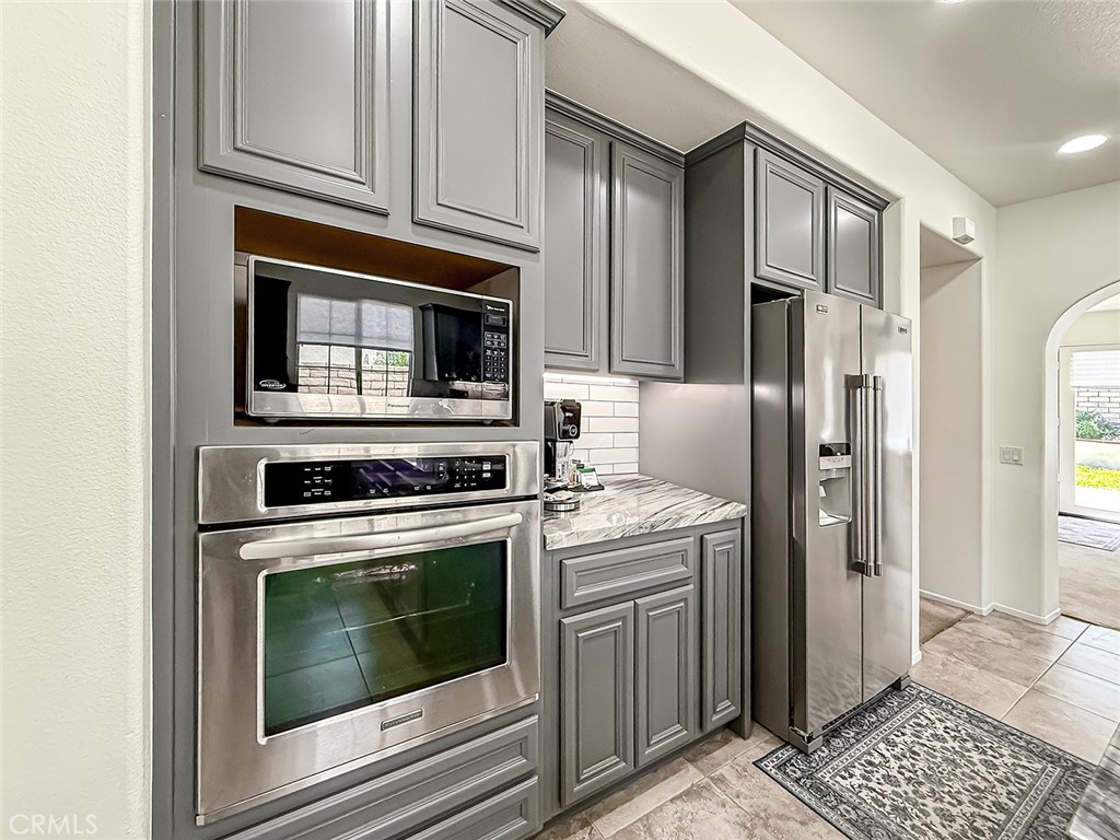 5244 Via Rincon Newbury Park, CA 91320 - Photo 11 of 19 a kitchen with stainless steel appliances granite countertop a stove a refrigerator and a microwave