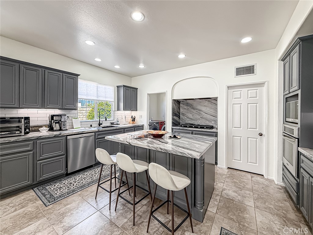 5244 Via Rincon Newbury Park, CA 91320 - Photo 9 of 19 a kitchen with a stove a sink and a refrigerator
