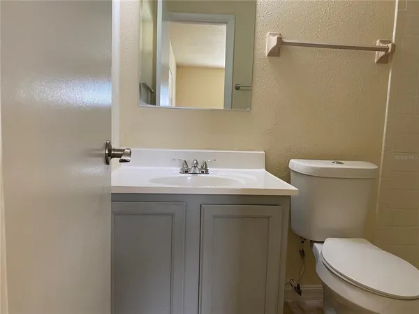 a bathroom with a sink toilet and a mirror