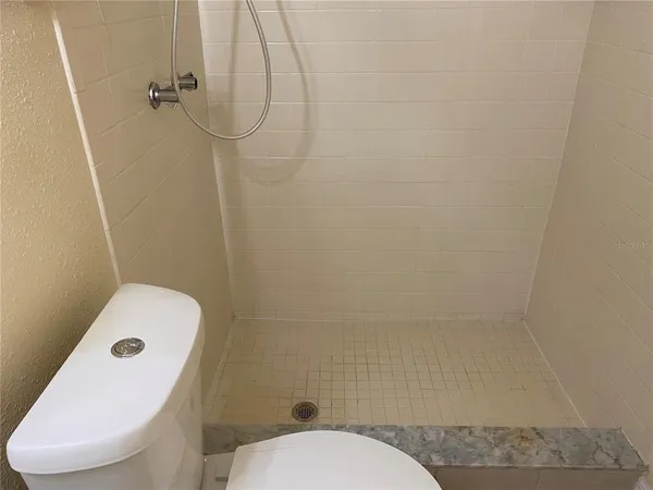 a bathroom with a toilet and a shower