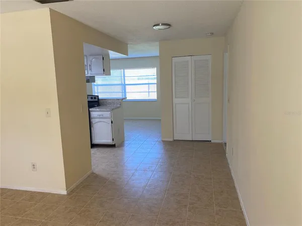a kitchen with white cabinets and a stove