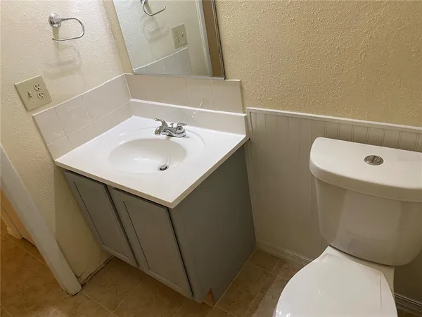 a bathroom with a sink a toilet and mirror