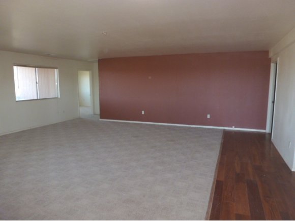 550 West Ranch House Road Paulden, AZ 86334 - Photo 5 of 6 an empty room with wooden floor and windows