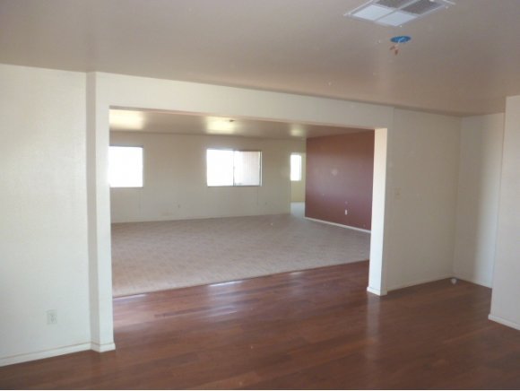 550 West Ranch House Road Paulden, AZ 86334 - Photo 6 of 6 an empty room with wooden floor and windows
