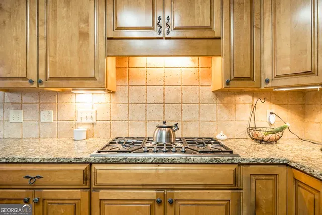 a kitchen with granite countertop a sink and a stove