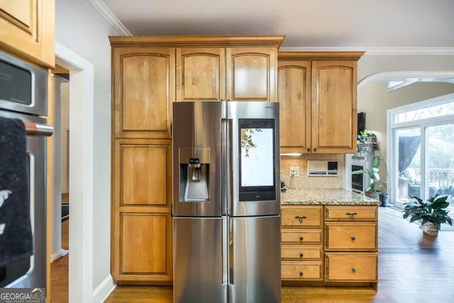 a kitchen with stainless steel appliances a refrigerator and cabinets