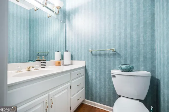 a bathroom with a sink mirror and toilet