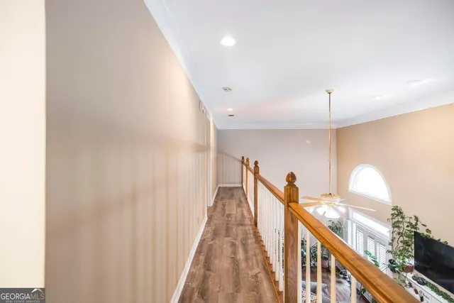 a spacious bedroom with a bed and wooden floor