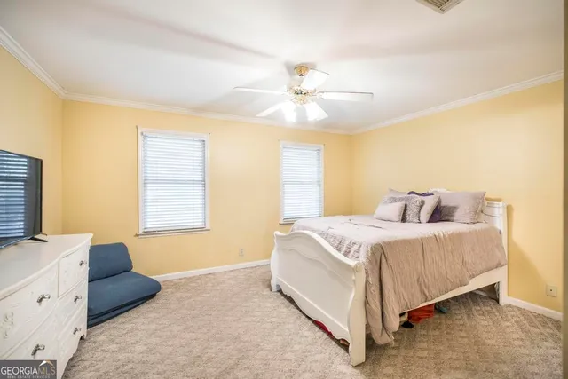 a bedroom with a bed and a television