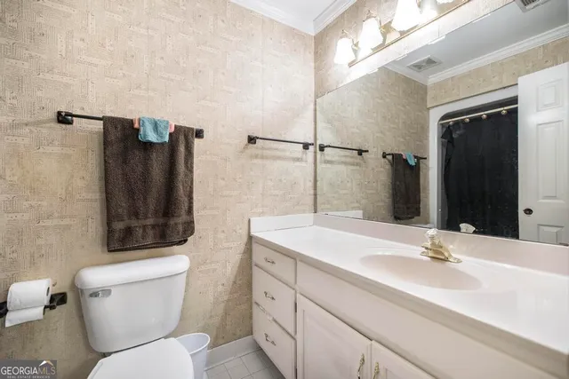 a bed room with a bed window and potted plant on it