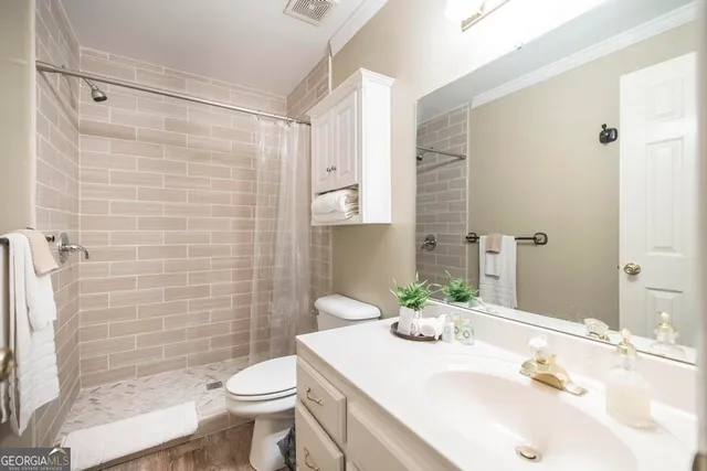 a bedroom with two beds and a chandelier