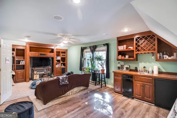 a room with stainless steel appliances a sink and a microwave