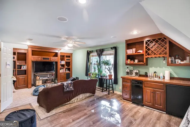 a room with stainless steel appliances a sink and a microwave