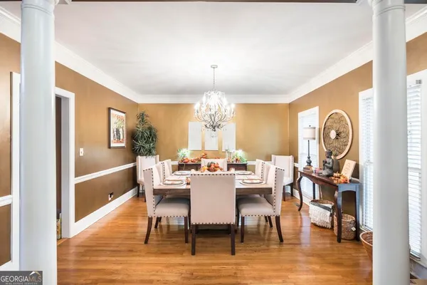 a view of a dining room with furniture window and wooden floor
