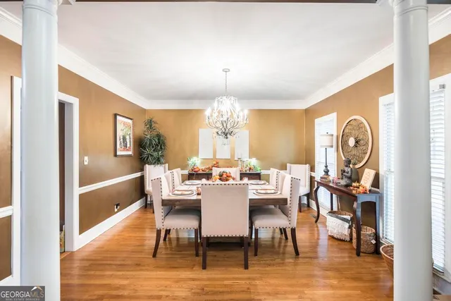a view of a dining room with furniture window and wooden floor