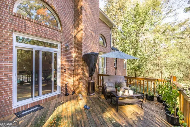 a view of backyard with swimming pool and seating space