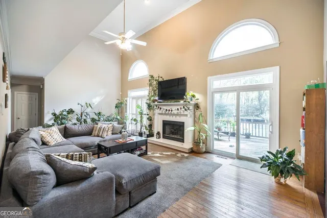 a living room with furniture a fireplace and a flat screen tv