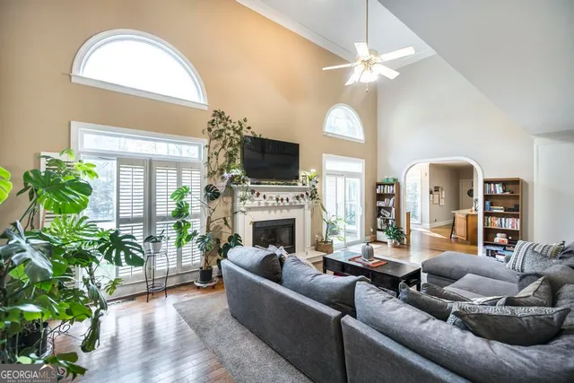 a living room with furniture a fireplace and a flat screen tv