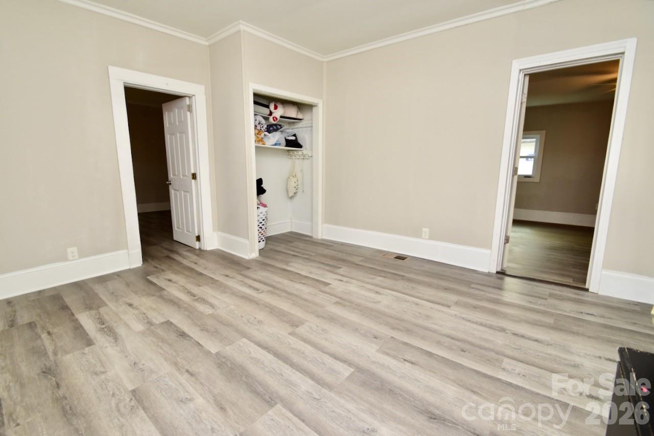 2007 South York Road Gastonia, NC 28052 - Photo 11 of 26 an empty room with wooden floor and closet