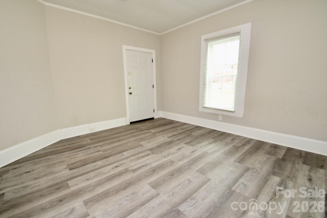 2007 South York Road Gastonia, NC 28052 - Photo 12 of 26 an empty room with wooden floor and windows