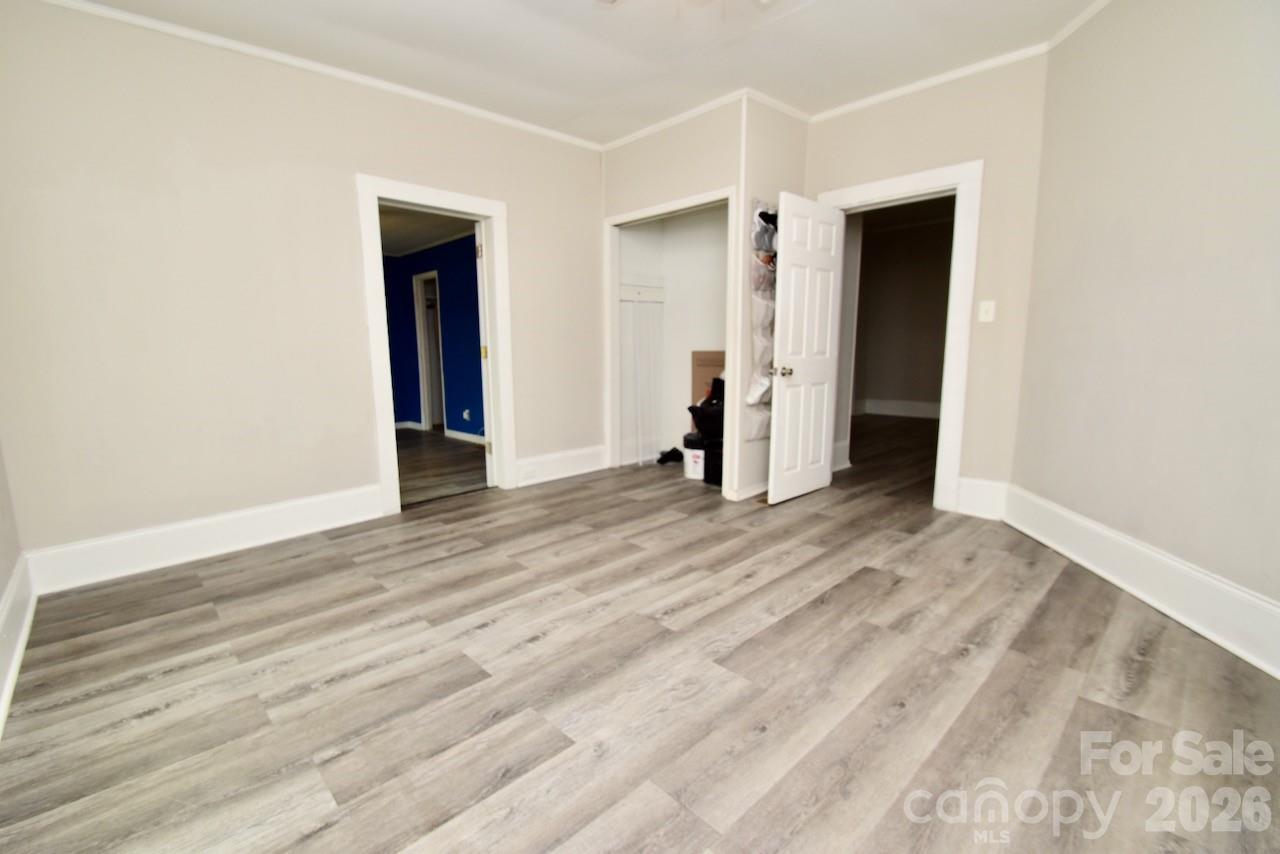 2007 South York Road Gastonia, NC 28052 - Photo 13 of 26 a view of an empty room with wooden floor and closet