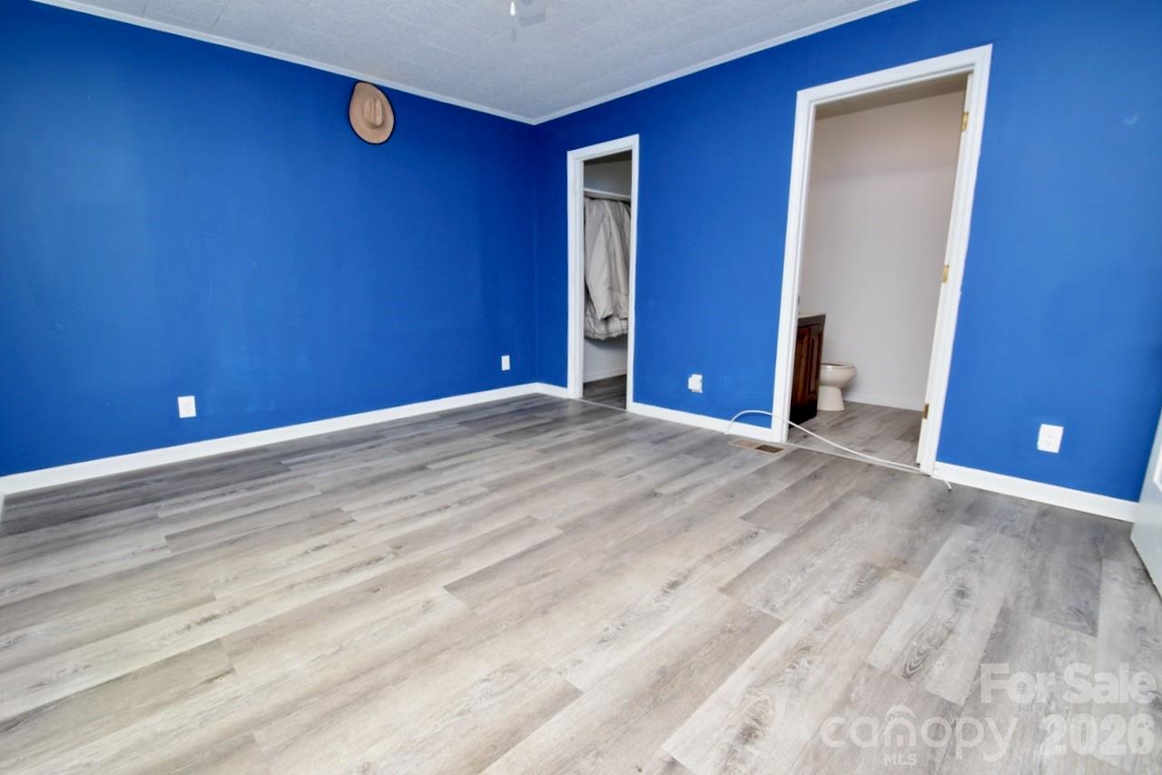 2007 South York Road Gastonia, NC 28052 - Photo 14 of 26 a view of an empty room with wooden floor and closet