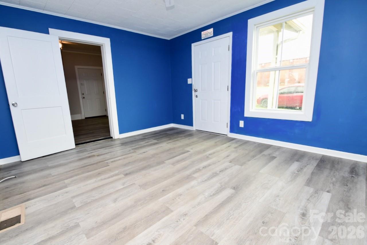 2007 South York Road Gastonia, NC 28052 - Photo 15 of 26 a view of an empty room with wooden floor and a window