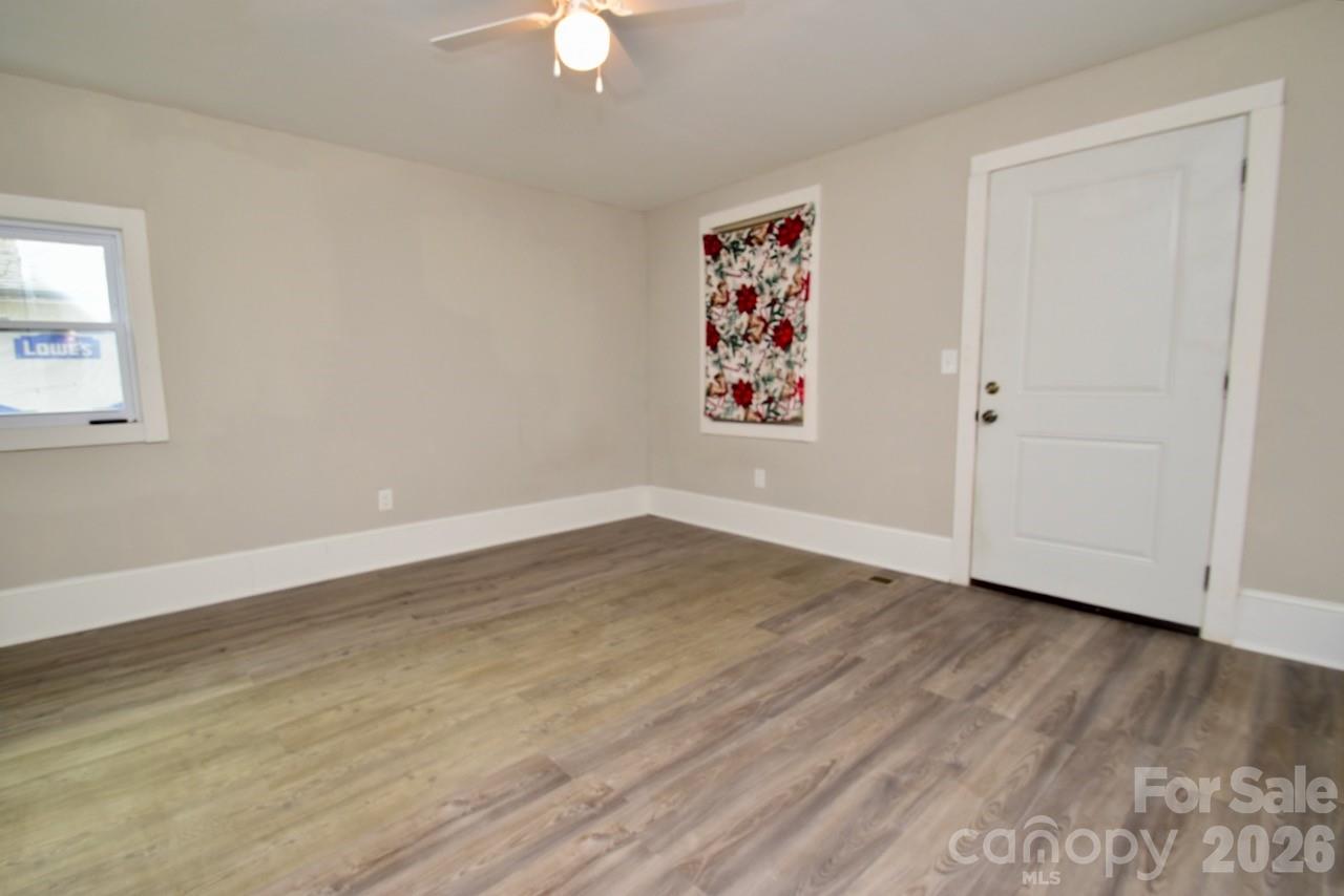 2007 South York Road Gastonia, NC 28052 - Photo 18 of 26 an empty room with wooden floor and window