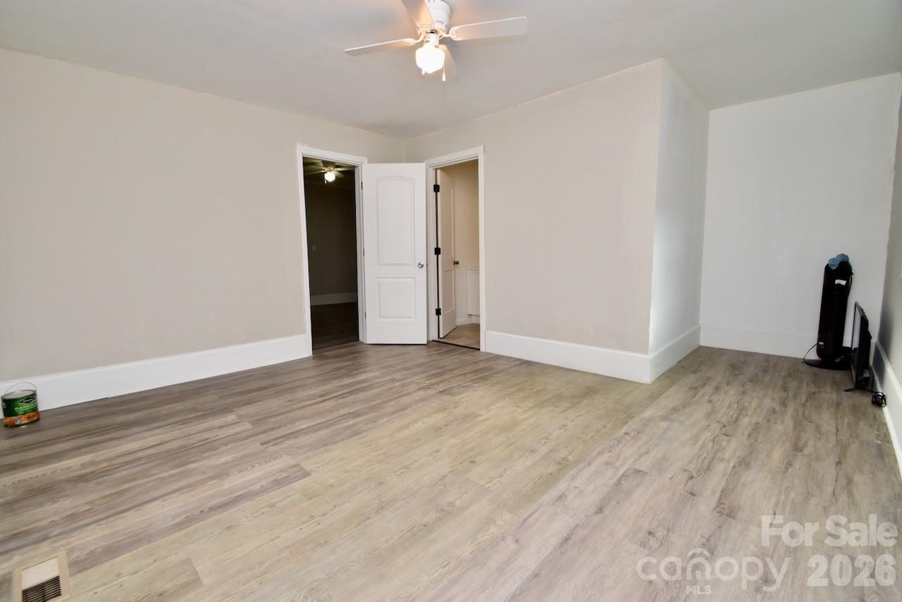 2007 South York Road Gastonia, NC 28052 - Photo 19 of 26 a view of a livingroom with wooden floor and a ceiling fan