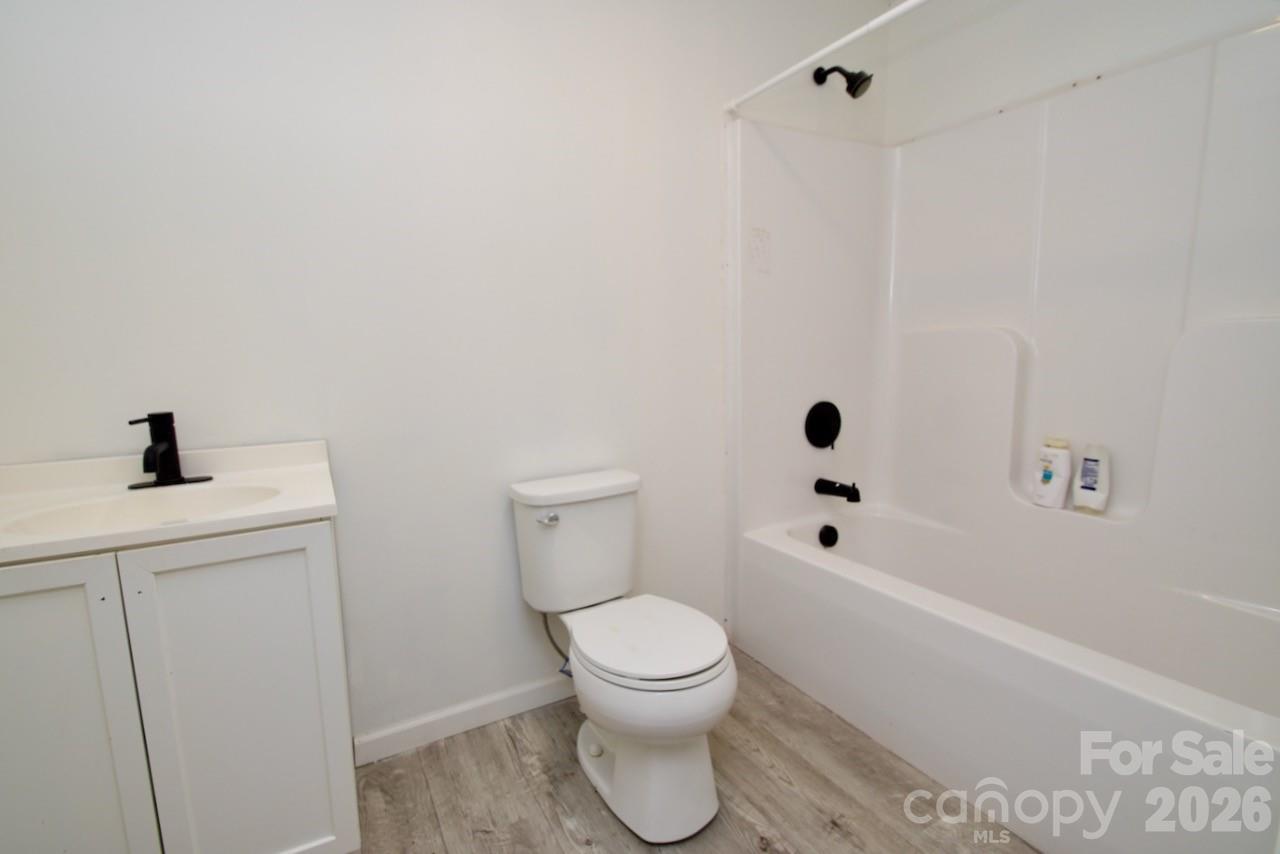 2007 South York Road Gastonia, NC 28052 - Photo 20 of 26 a bathroom with a toilet a sink and a bathtub