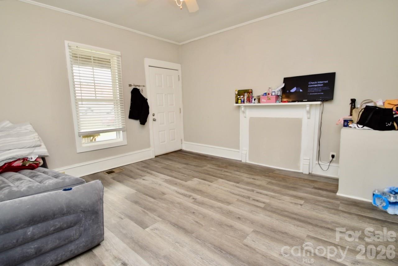 2007 South York Road Gastonia, NC 28052 - Photo 4 of 26 a view of a bedroom with wooden floor and cabinet