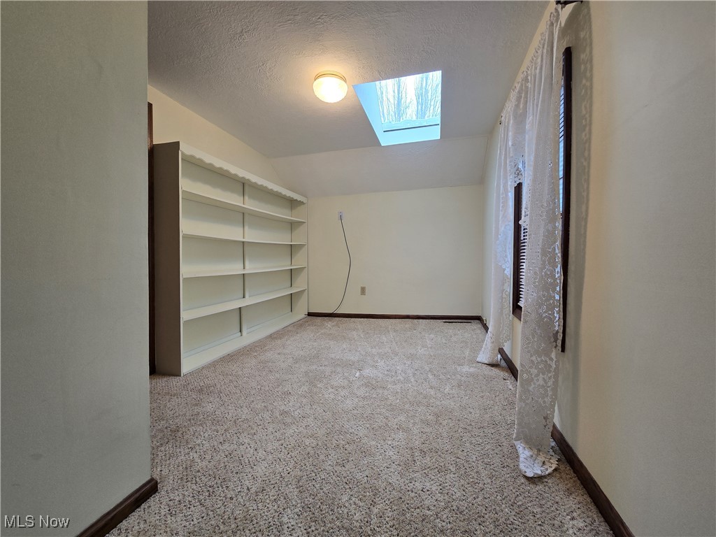 4300 Poe Road Medina, OH 44256 - Photo 29 of 45 2nd bedroom or office with shelving unit and skylight
