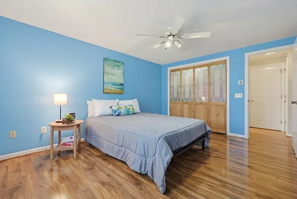a bedroom with a bed and a chandelier